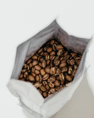 brown coffee beans inside white sack