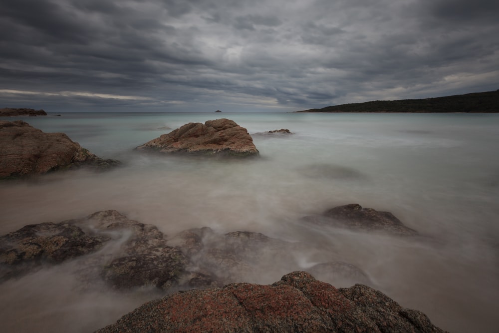 grey fogs covering the sea under grey cloudy sky