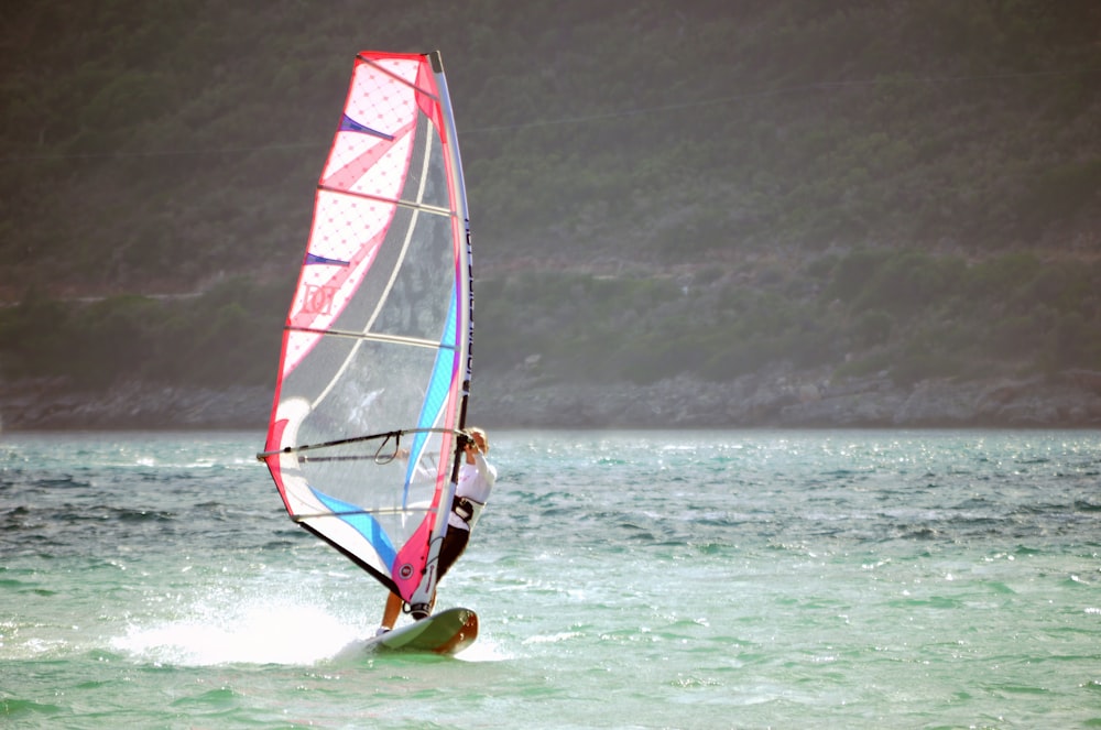 man wearing white shirt doing surfing