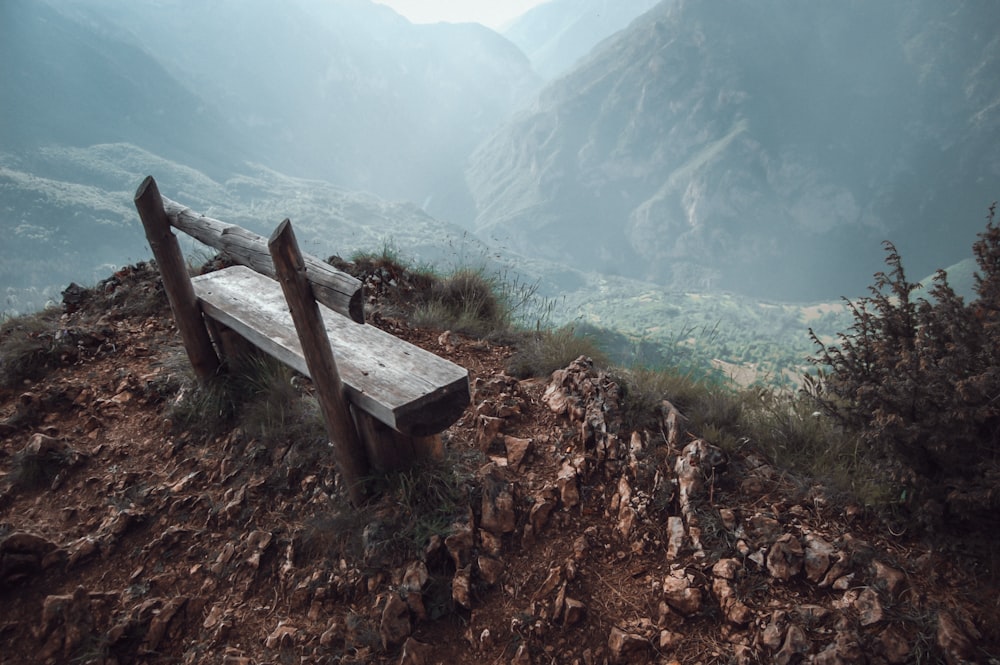 brown wooden bench on mountain
