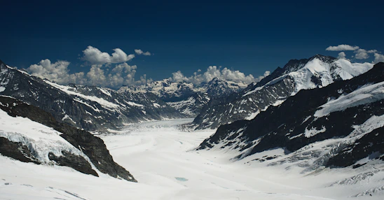 A breathtaking panoramic shot of a towering ice mountain under a clear blue sky.