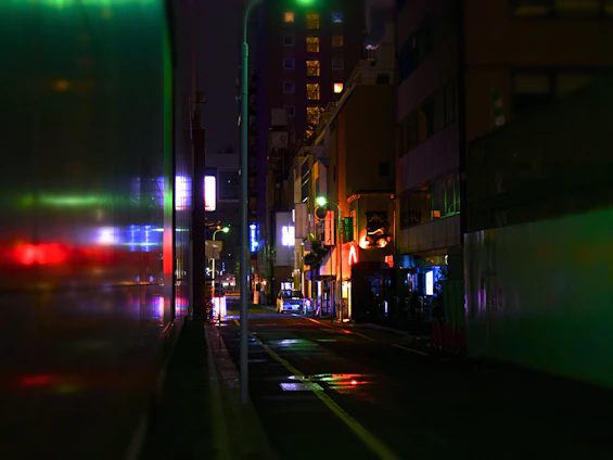 A sleek, dark cityscape at night with subtle glowing lights reflecting off wet streets, evoking a cinematic urban vibe.