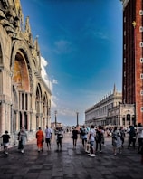 Historic city square filled with vibrant architecture and people.