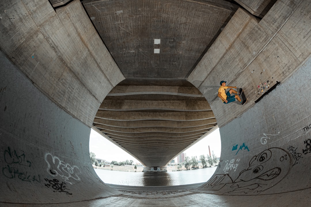 skateboarder under bridge