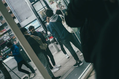 A group of friends in mixed urbanpulse streetwear laughing on a busy city street.