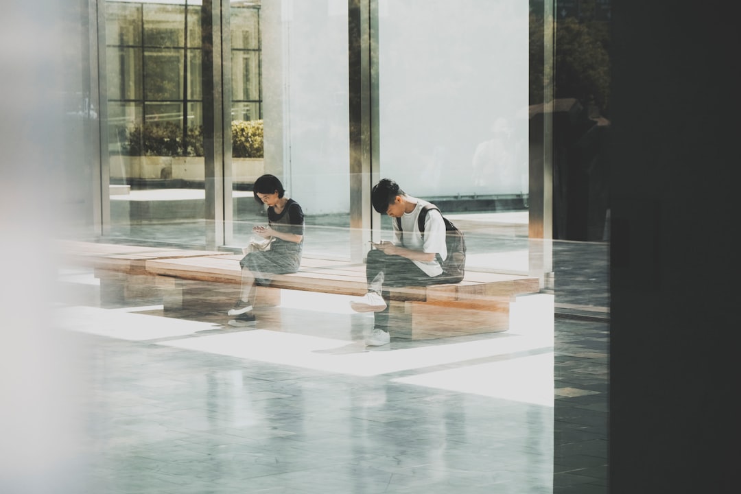 woman and man sitting on bench