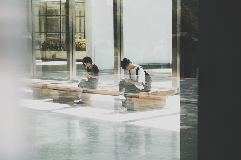 woman and man sitting on bench