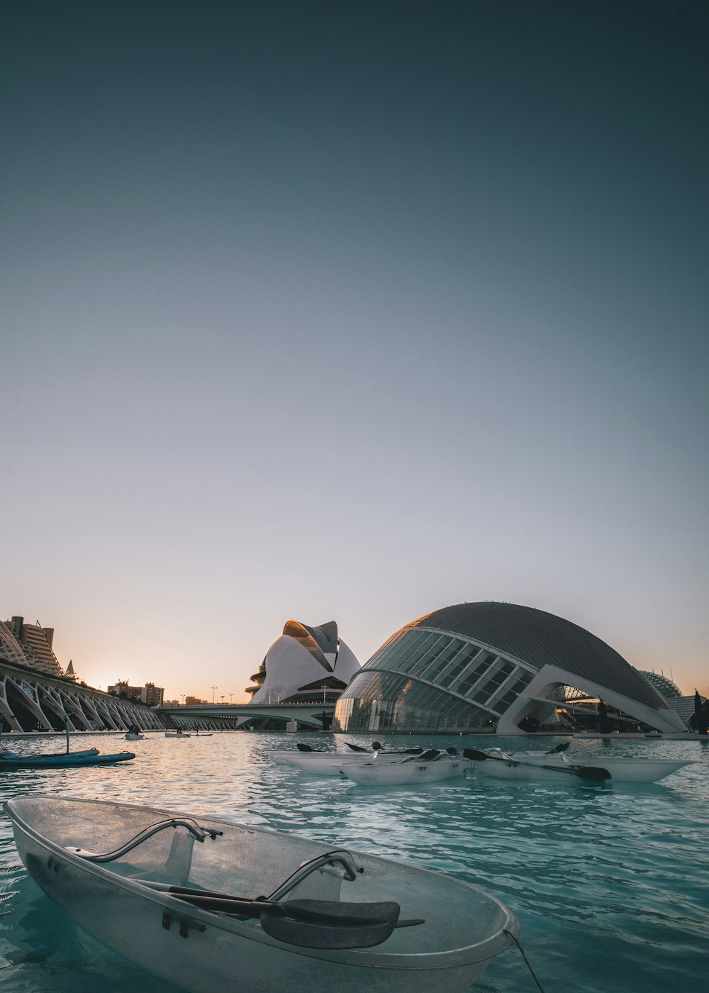 empty boats in water near grey domed building