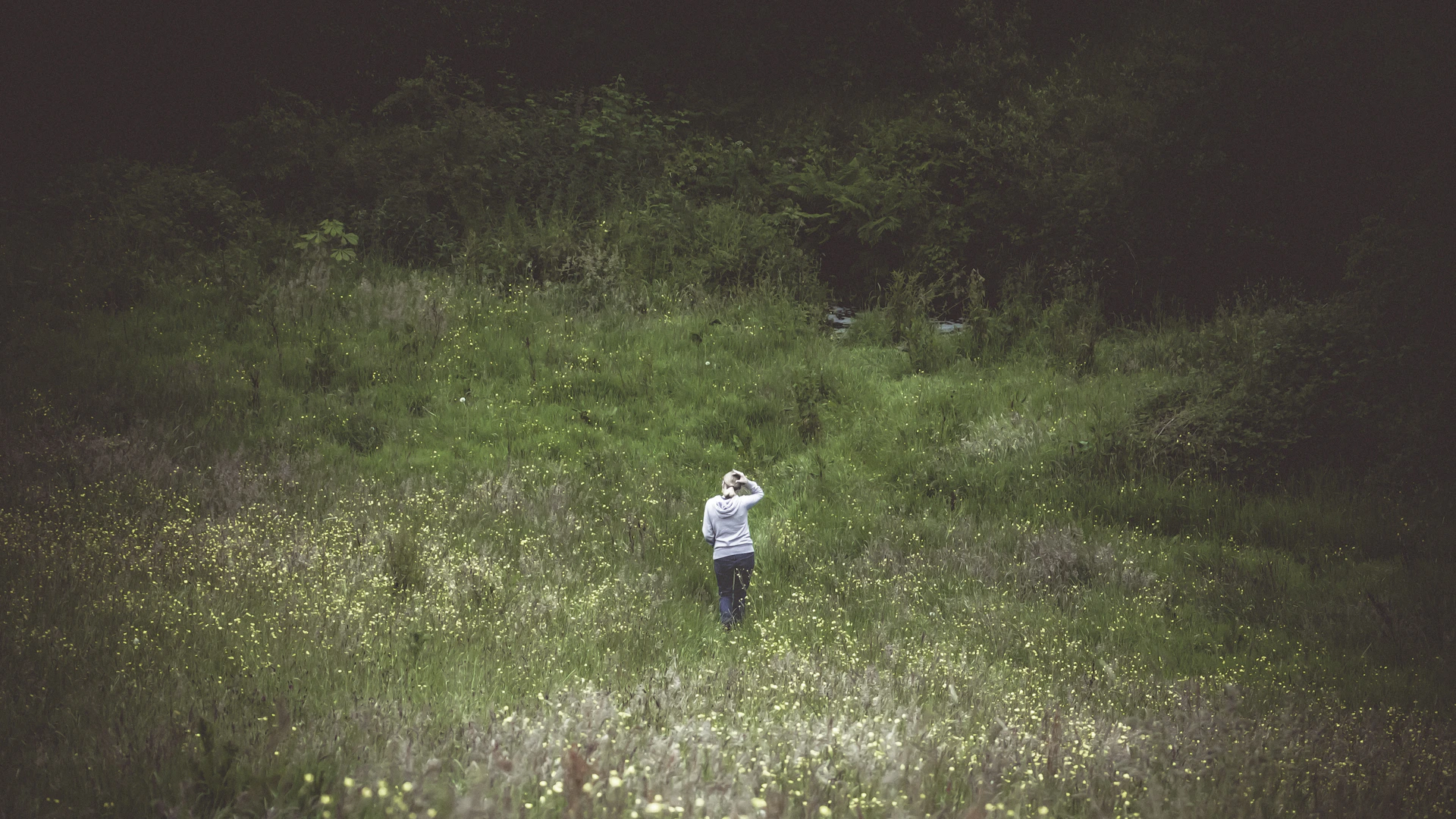 woman standing on green field