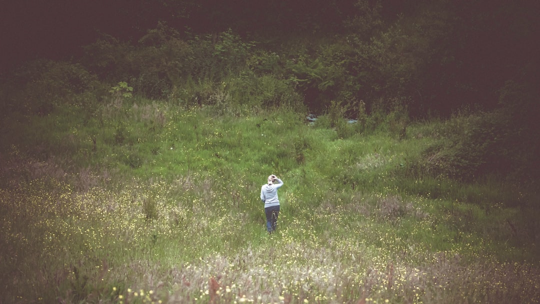 woman standing on green field