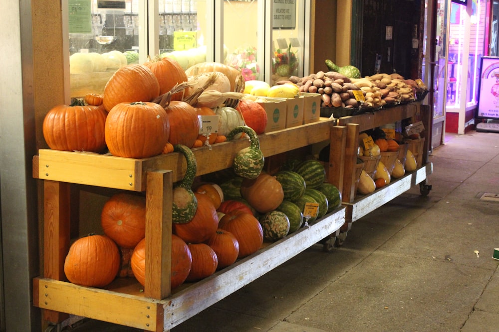 orange pumpkins on rack in front of store