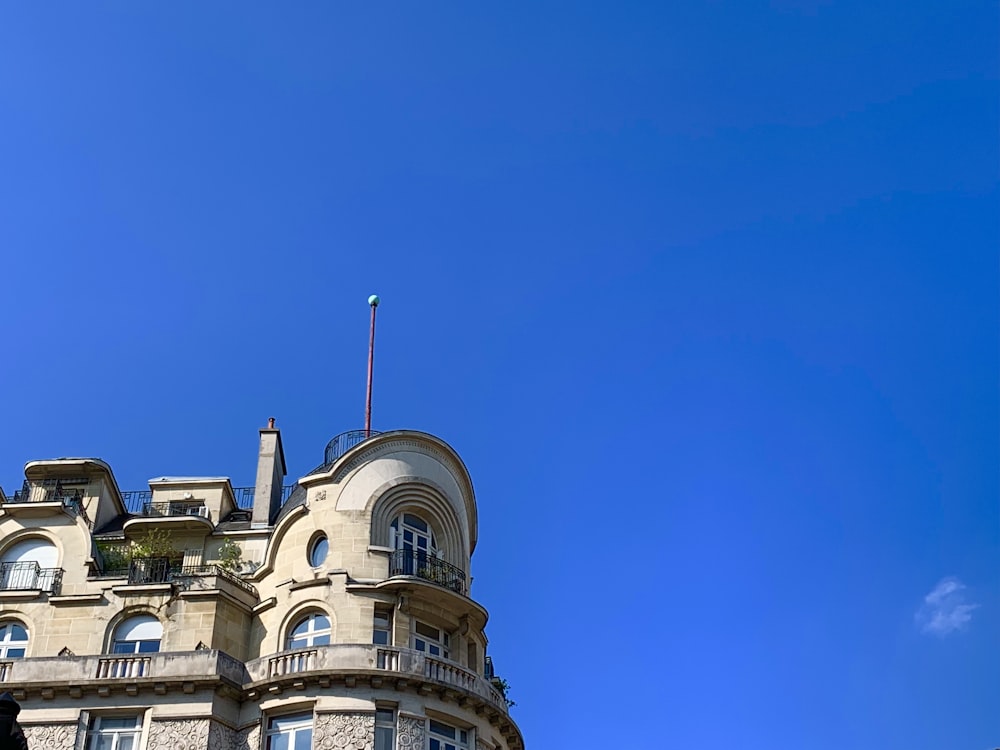 a tall building with a flag on top of it