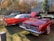 Several classic cars are parked on a grassy area. The vibrant red and orange vehicles appear to be from the mid-20th century, featuring convertible roofs and polished chrome details. In the background, autumn trees and a modern building add to the setting. A bright, sunny day casts soft shadows, enhancing the warm tones of the scene.