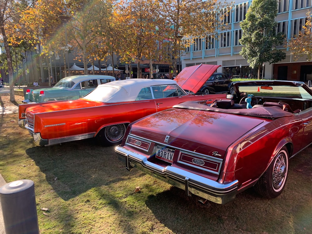 red coupe parked on grass field