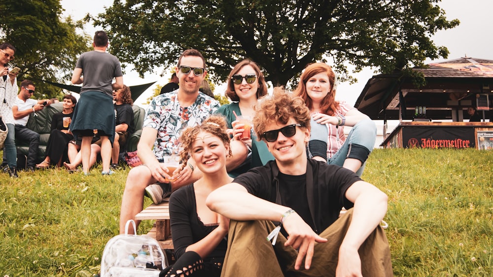 people sitting on grass field at day