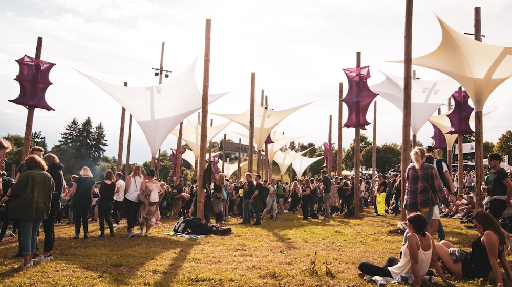 people standing on grass field