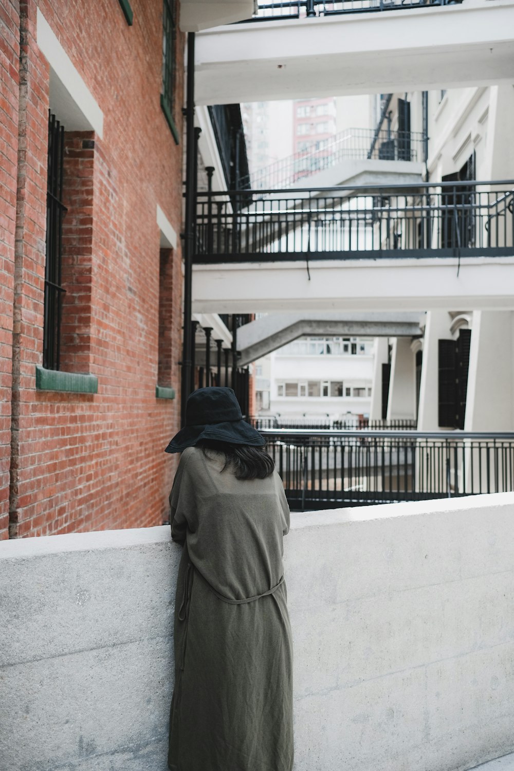 woman standing on gray wall