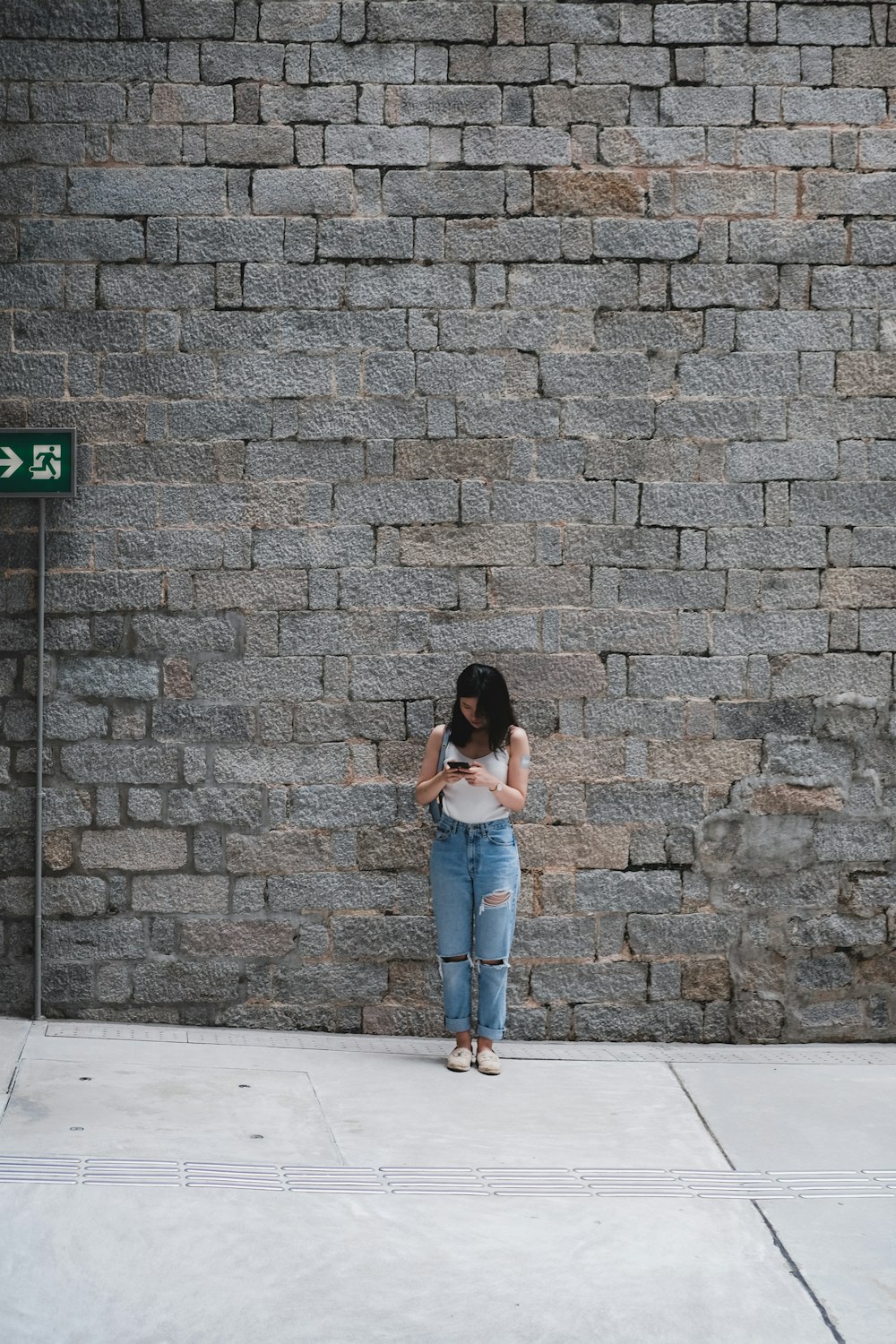 woman standing in front of gray wall