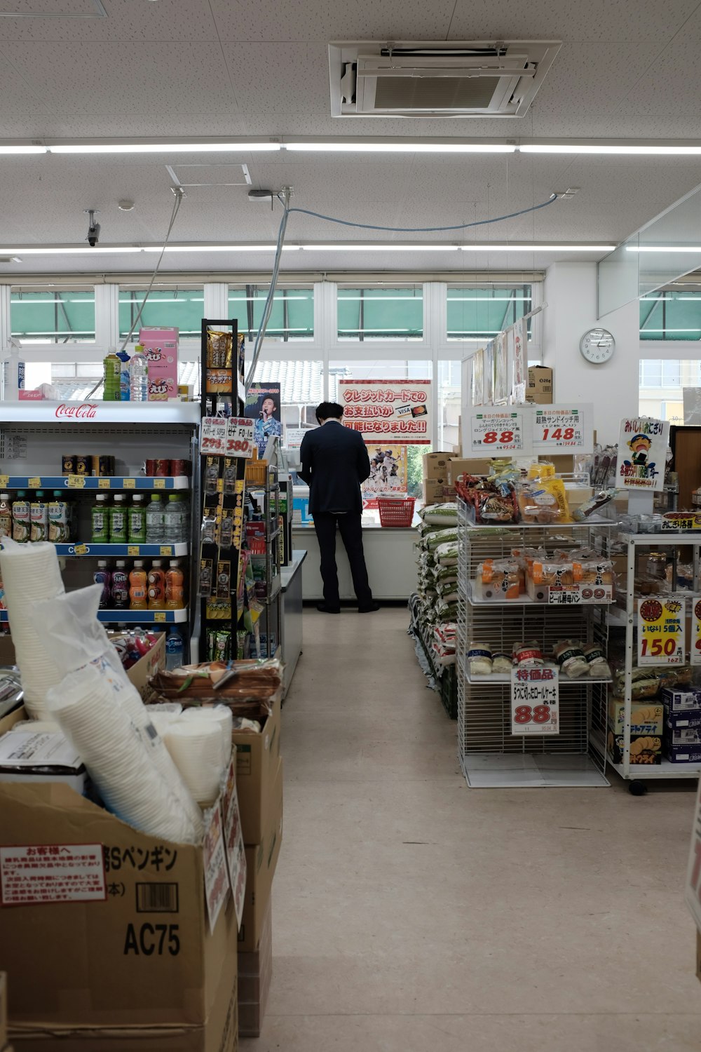 man standing on store counter during daytime