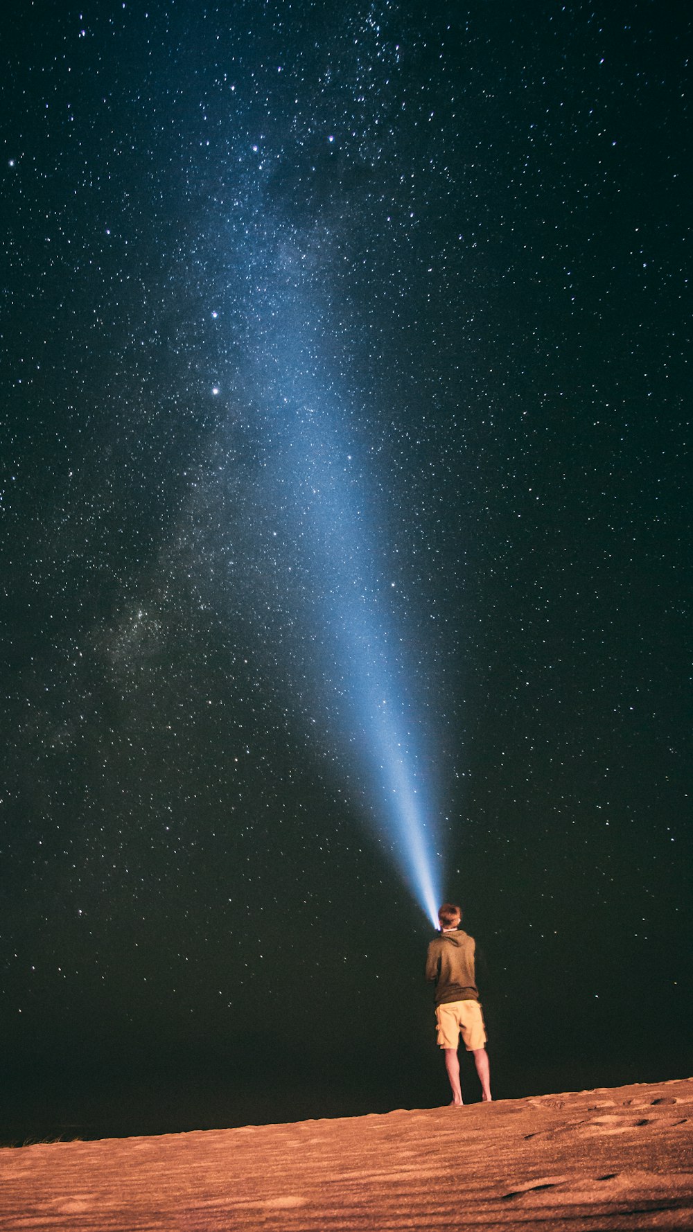 man looking at a starry filled sky