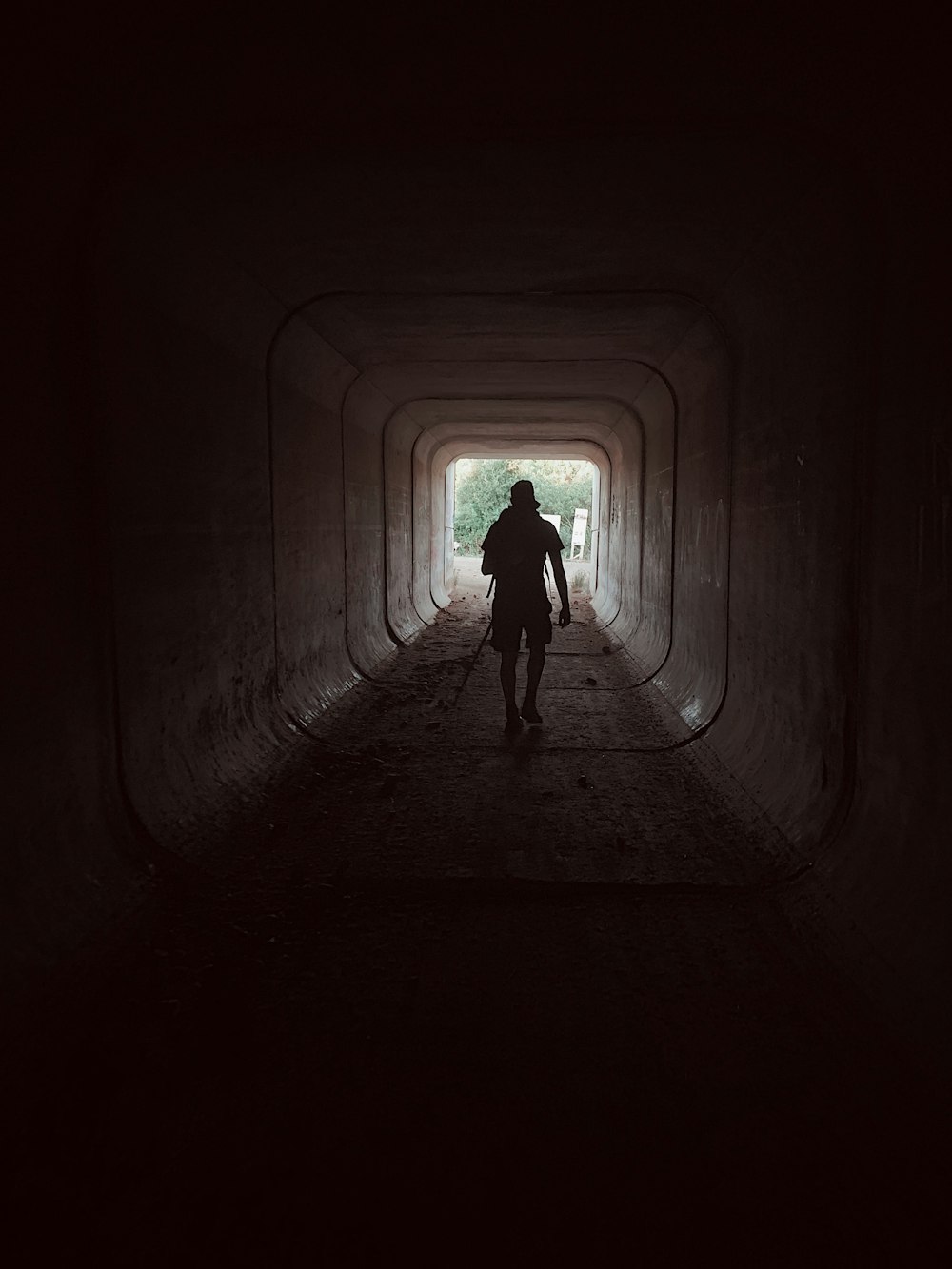 person walking in tunnel