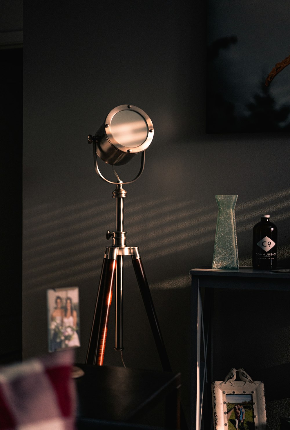 a tripod light sitting on top of a wooden table