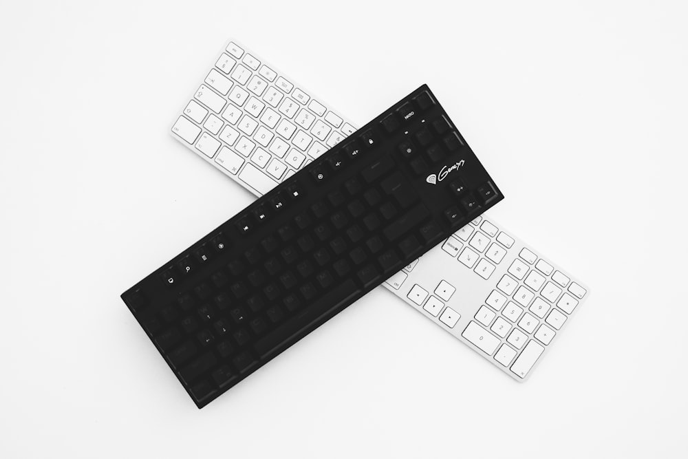 two black and white wireless keyboards