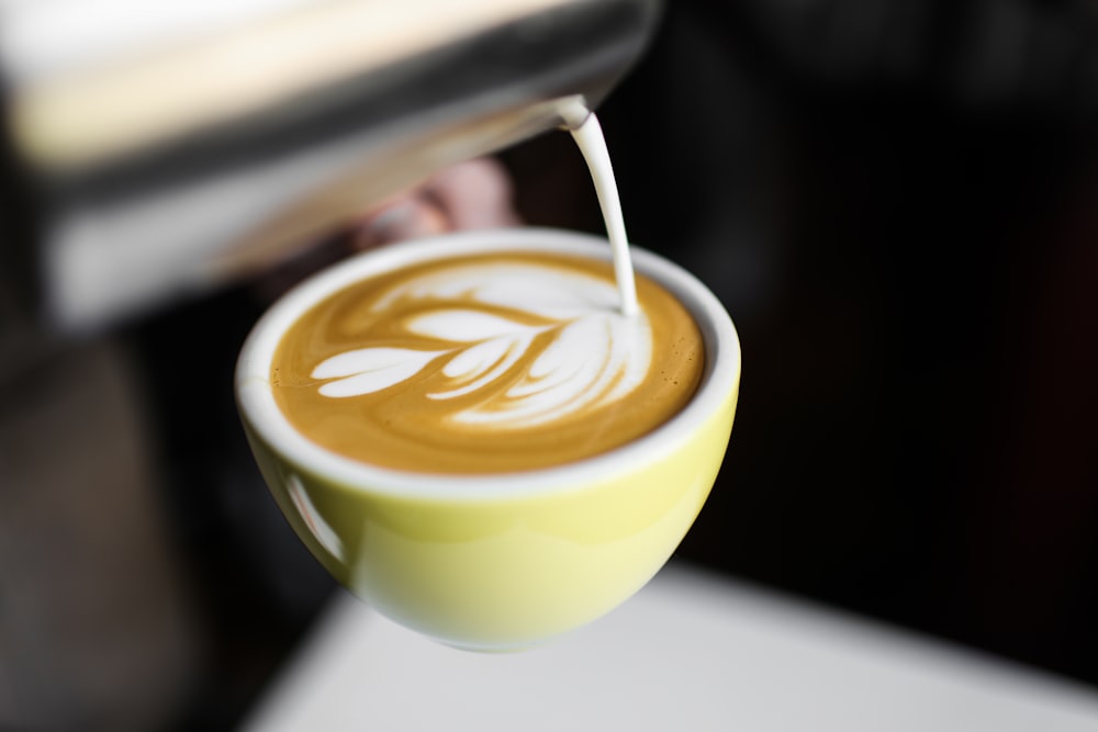 selective focus photography of teacup with coffee lathe