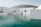 white concrete structure beside body of water