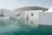 white concrete structure beside body of water