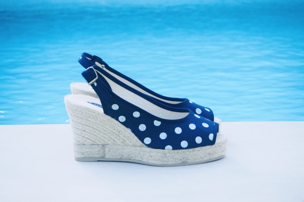 pair of blue and white polka dot wedge heeled sandals
