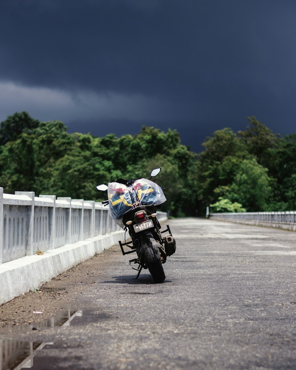 white black motorcycle on a bridge