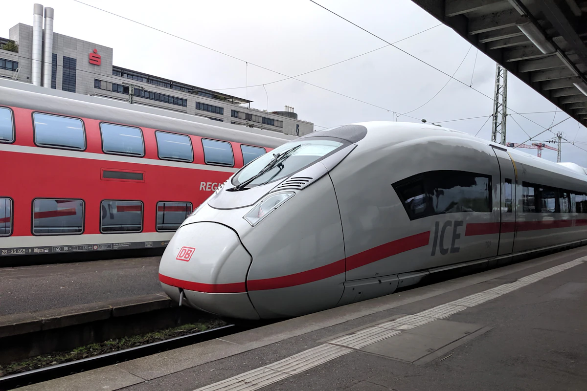 A high-speed train waiting at a European station platform