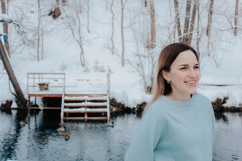 woman in green by a pond at winter