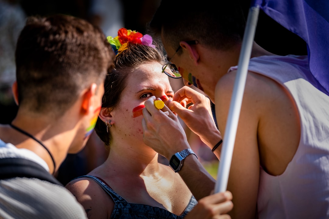 person putting makeup on woman