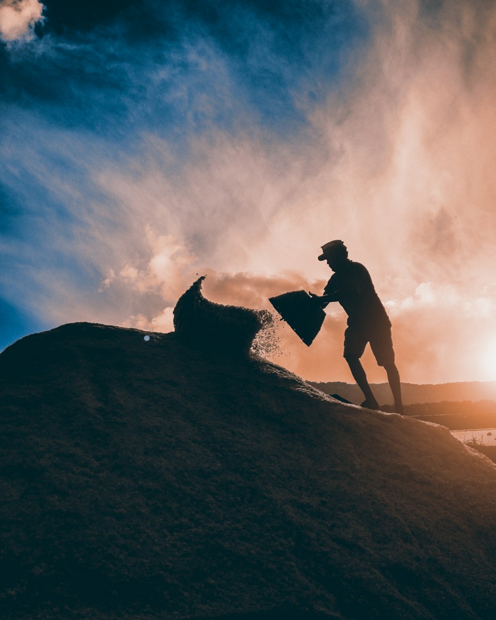 man shoving sand