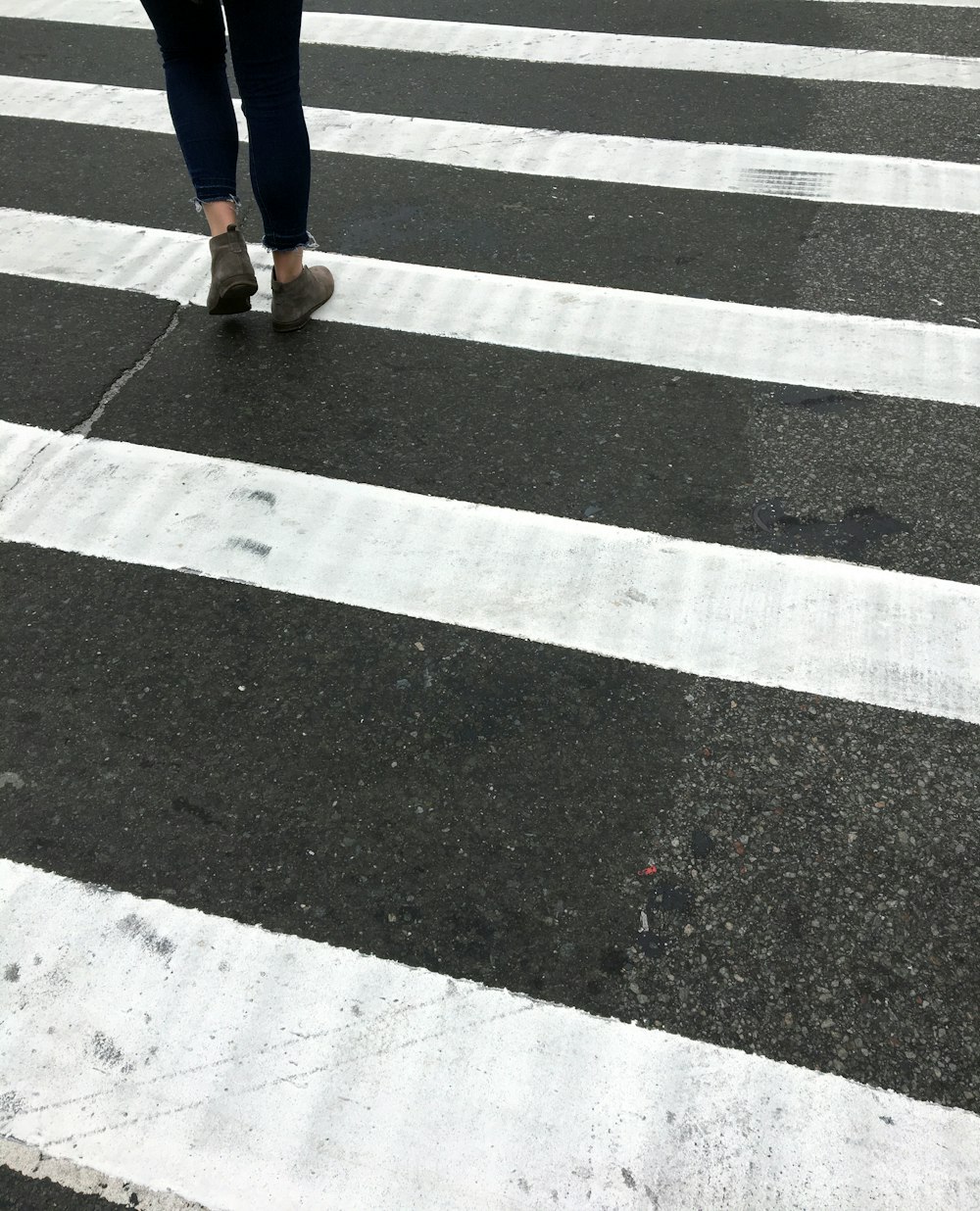 person walking at the pedestrian lane