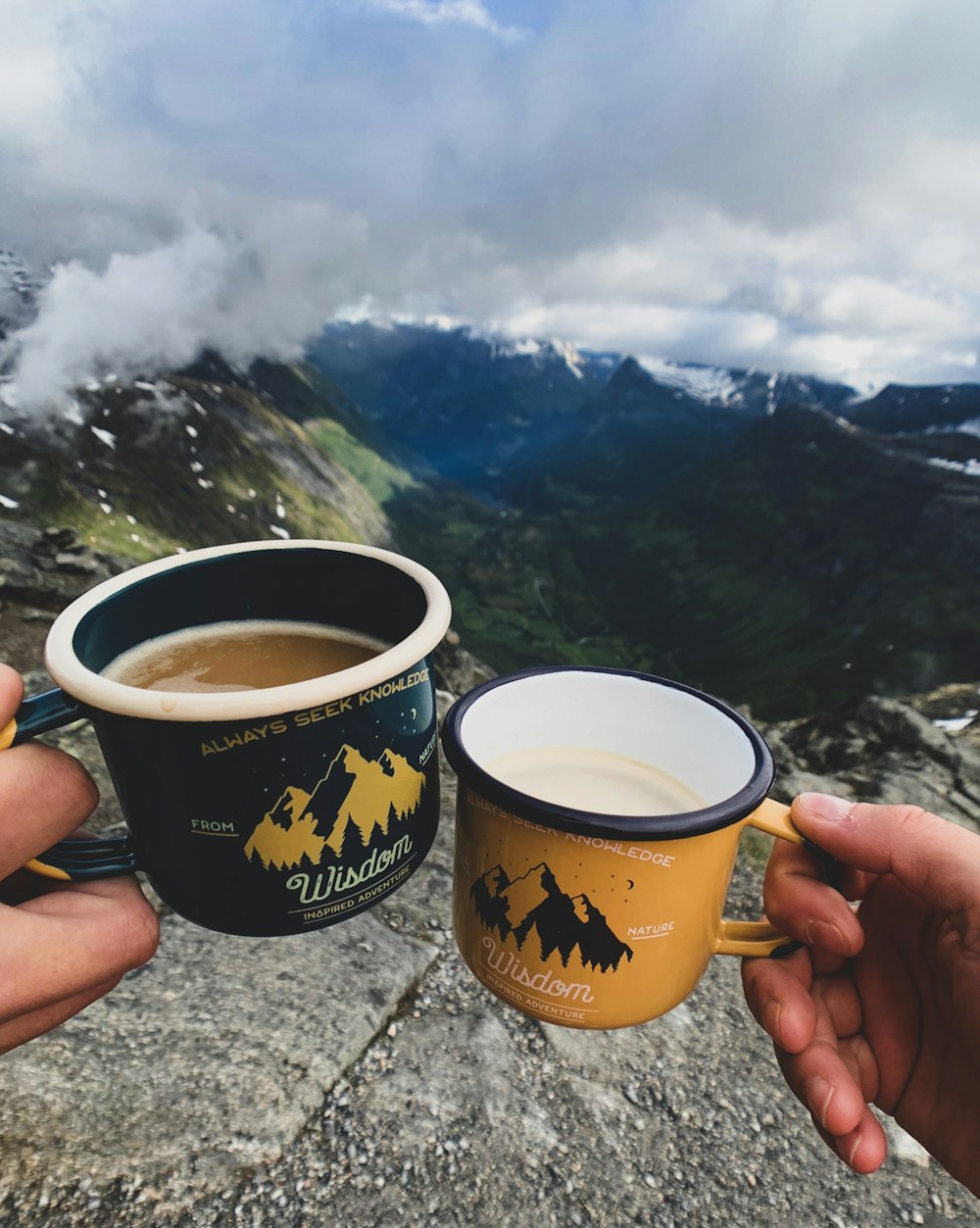 two persons holding mugs