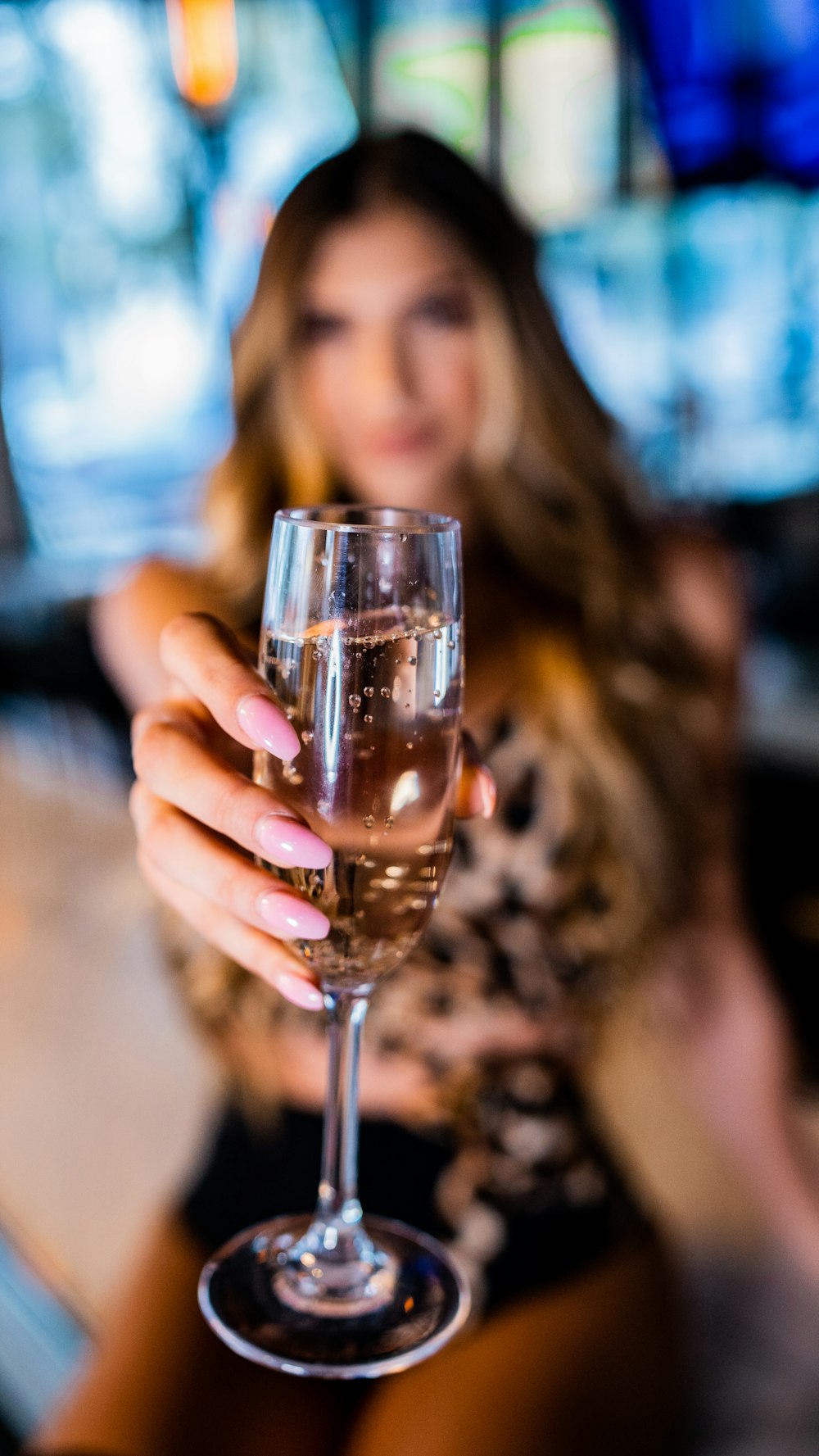 woman holding clear wine glass