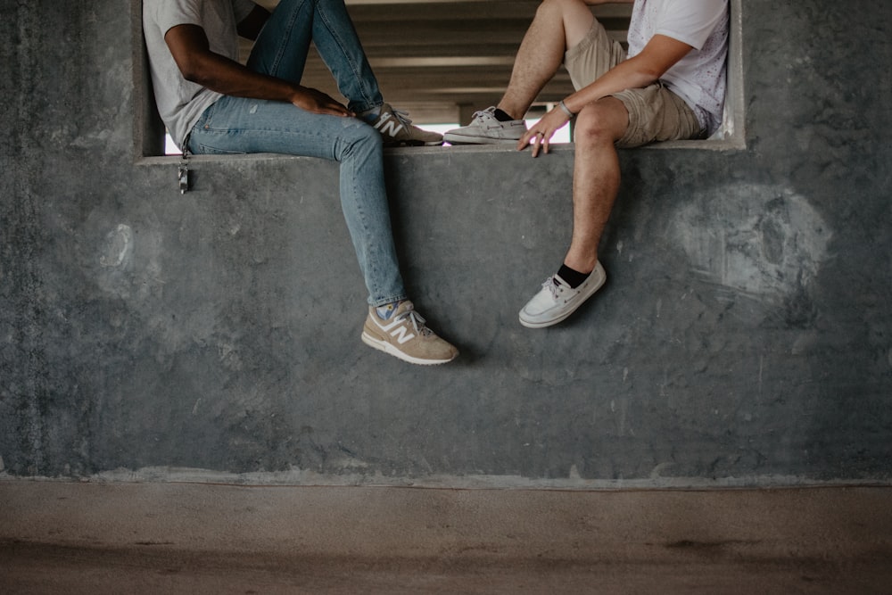 two men sitting on window