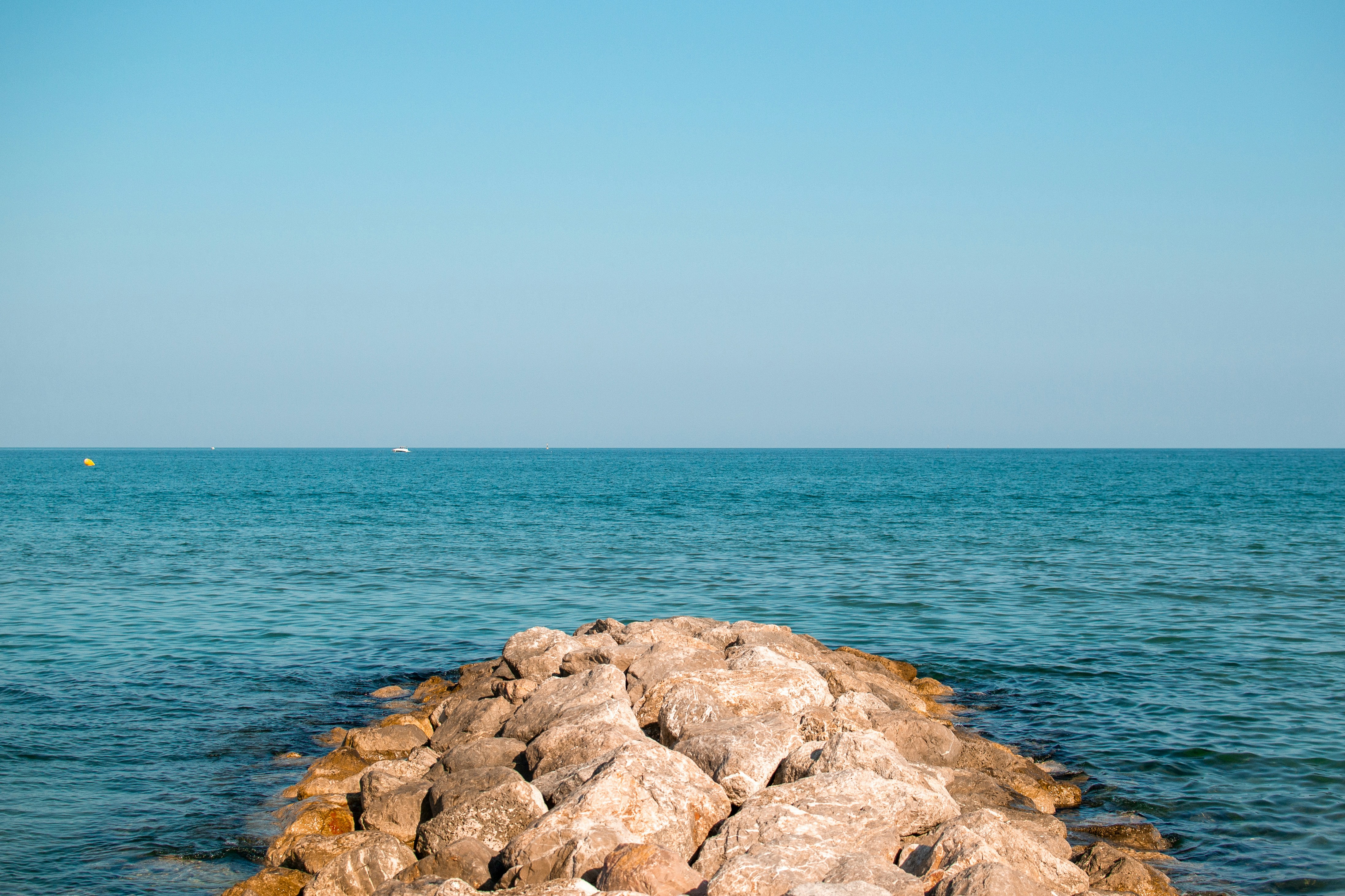 pile of rocks leading to the sea