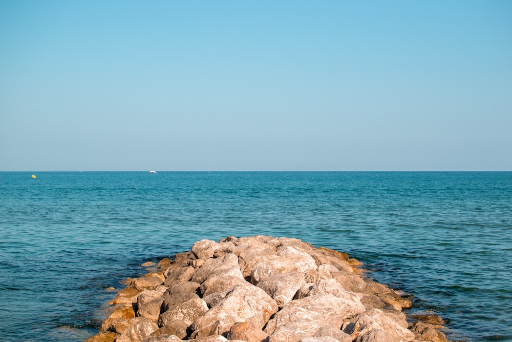 pile of rocks leading to the sea