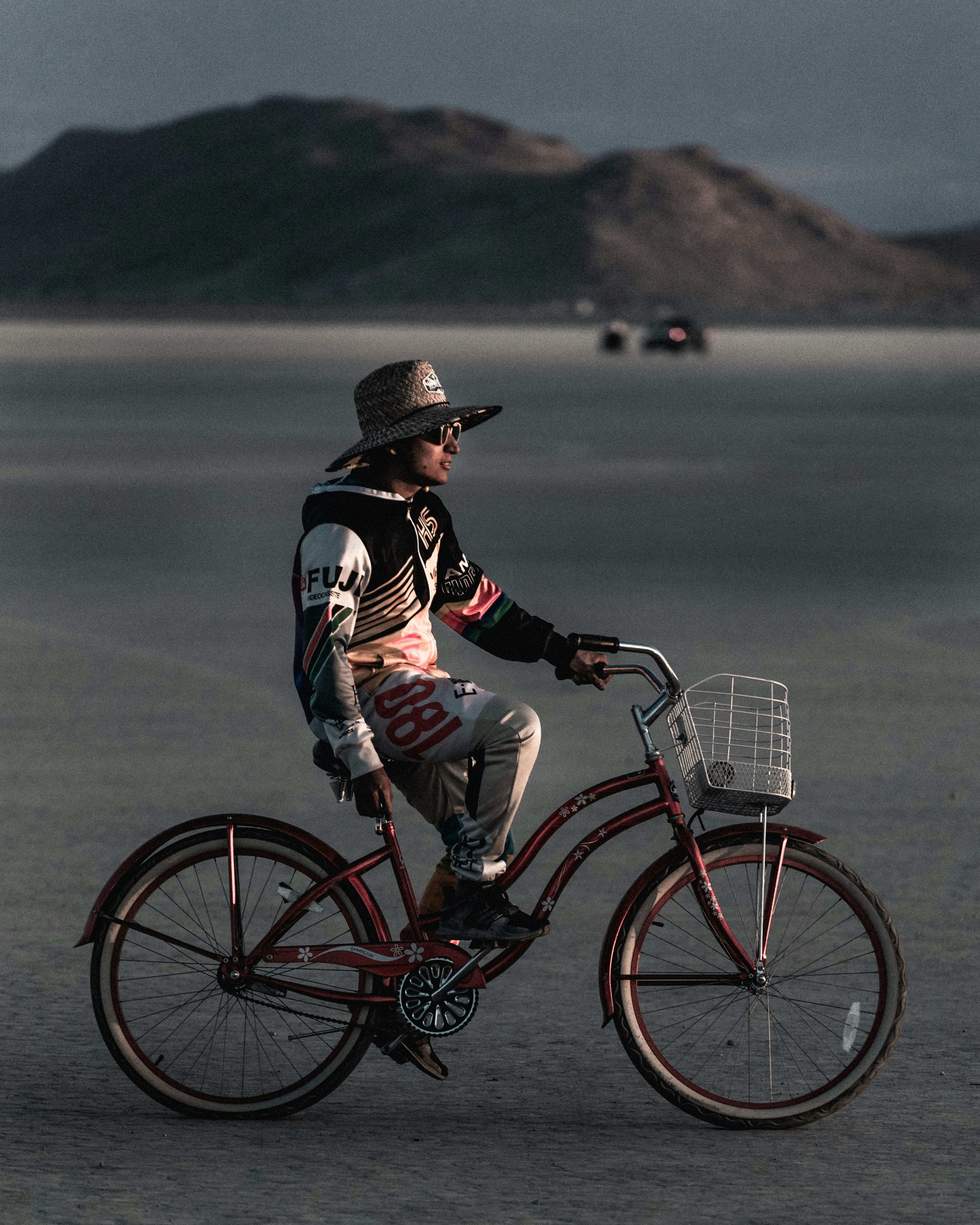 man in black and white hooded jacket riding bicycle