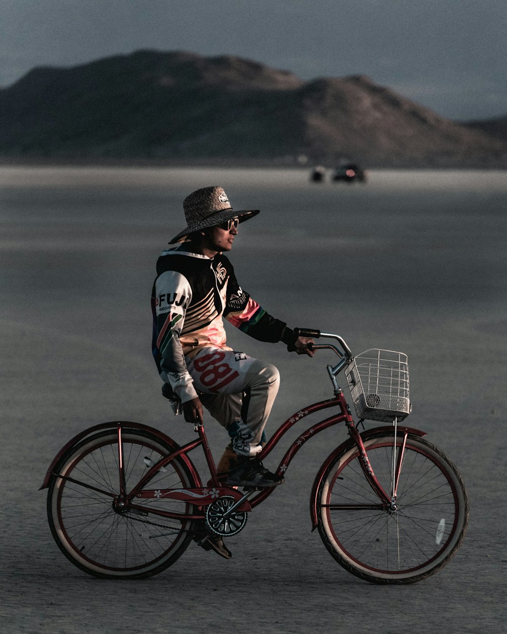 man in black and white hooded jacket riding bicycle