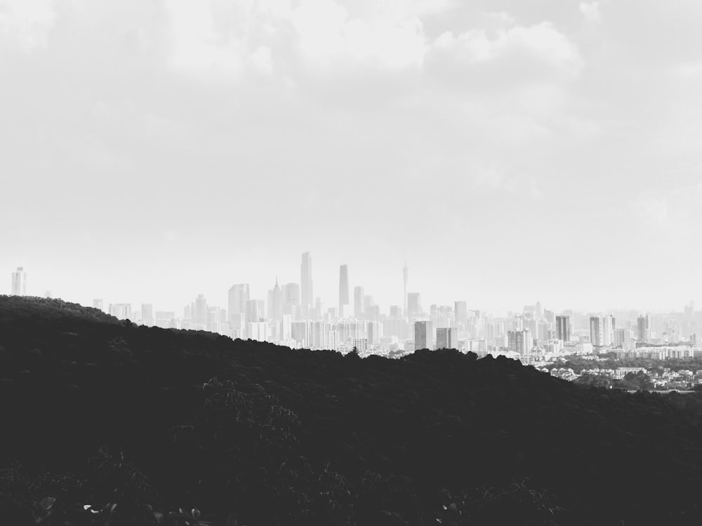 grayscale photo of mountain and buildings