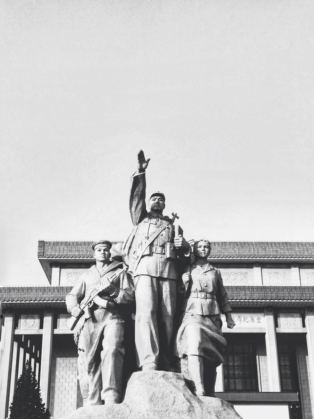 three people standing statue