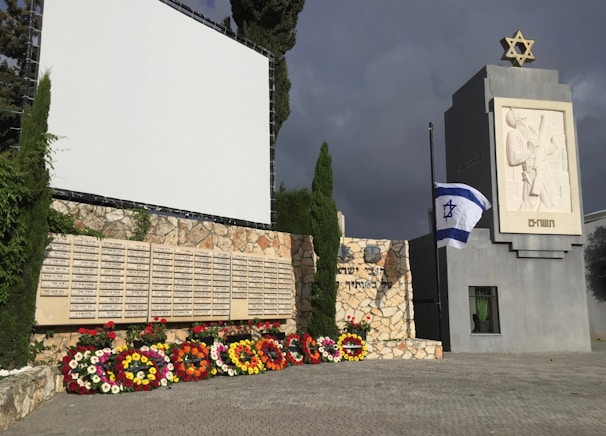Volunteers gently arranging flowers at a community memorial event in Hod Hasharon.