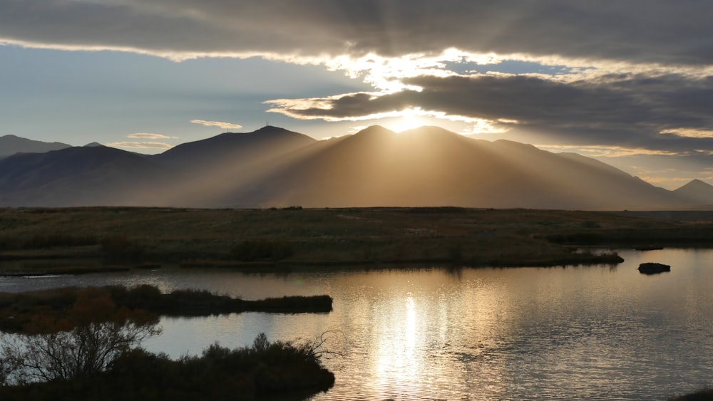 lake and mountain during sunrise