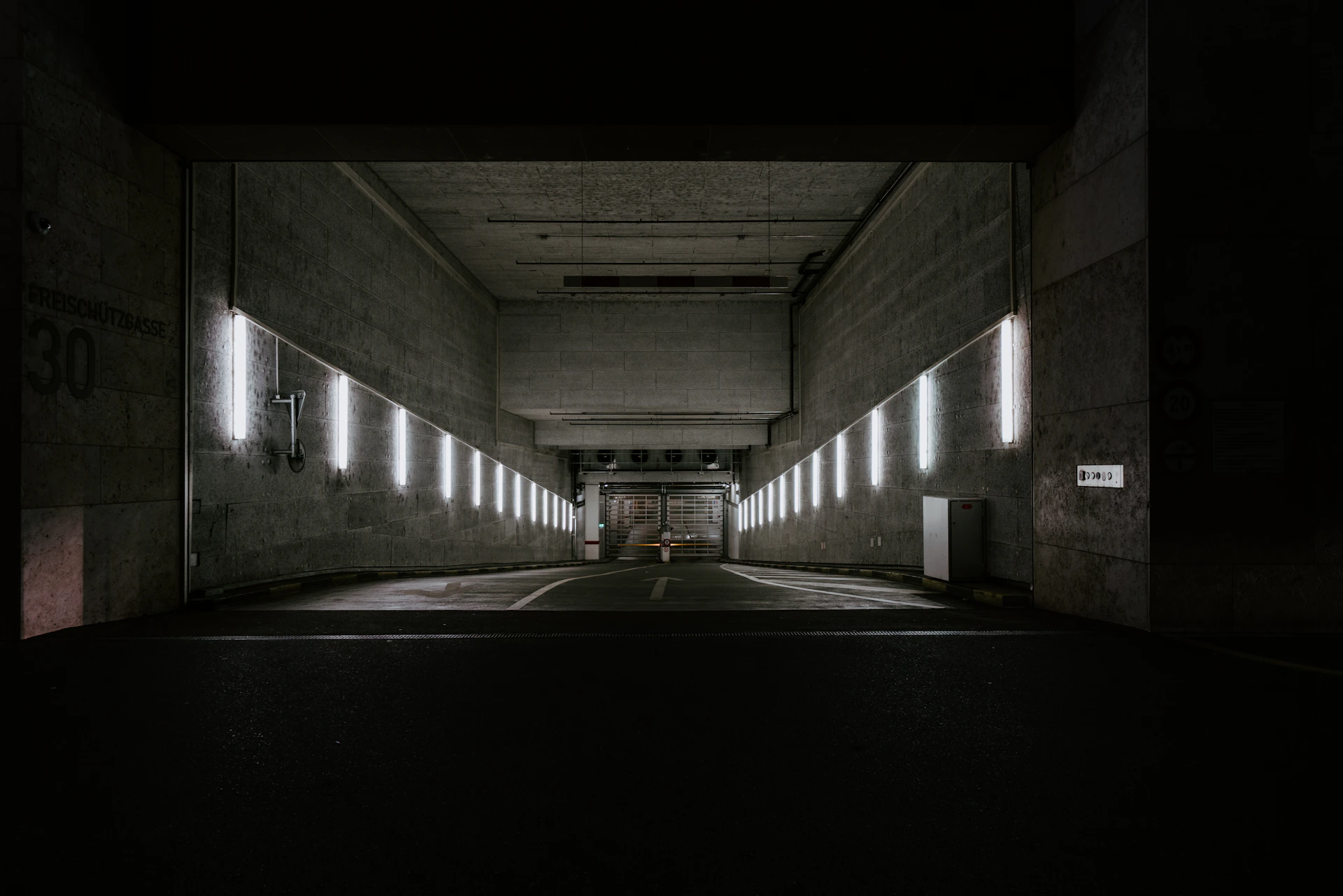 a dark tunnel with lights on the side of it