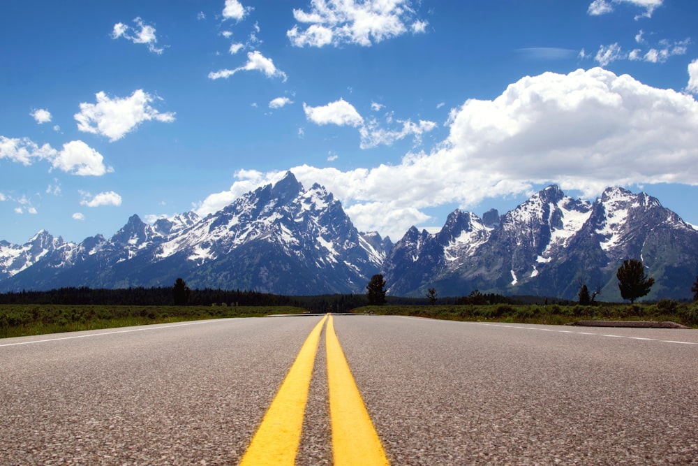 concrete road leading to the mountain alps